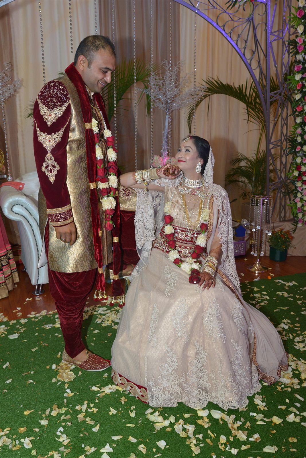 Bride and groom walking an aisle strewn with petals